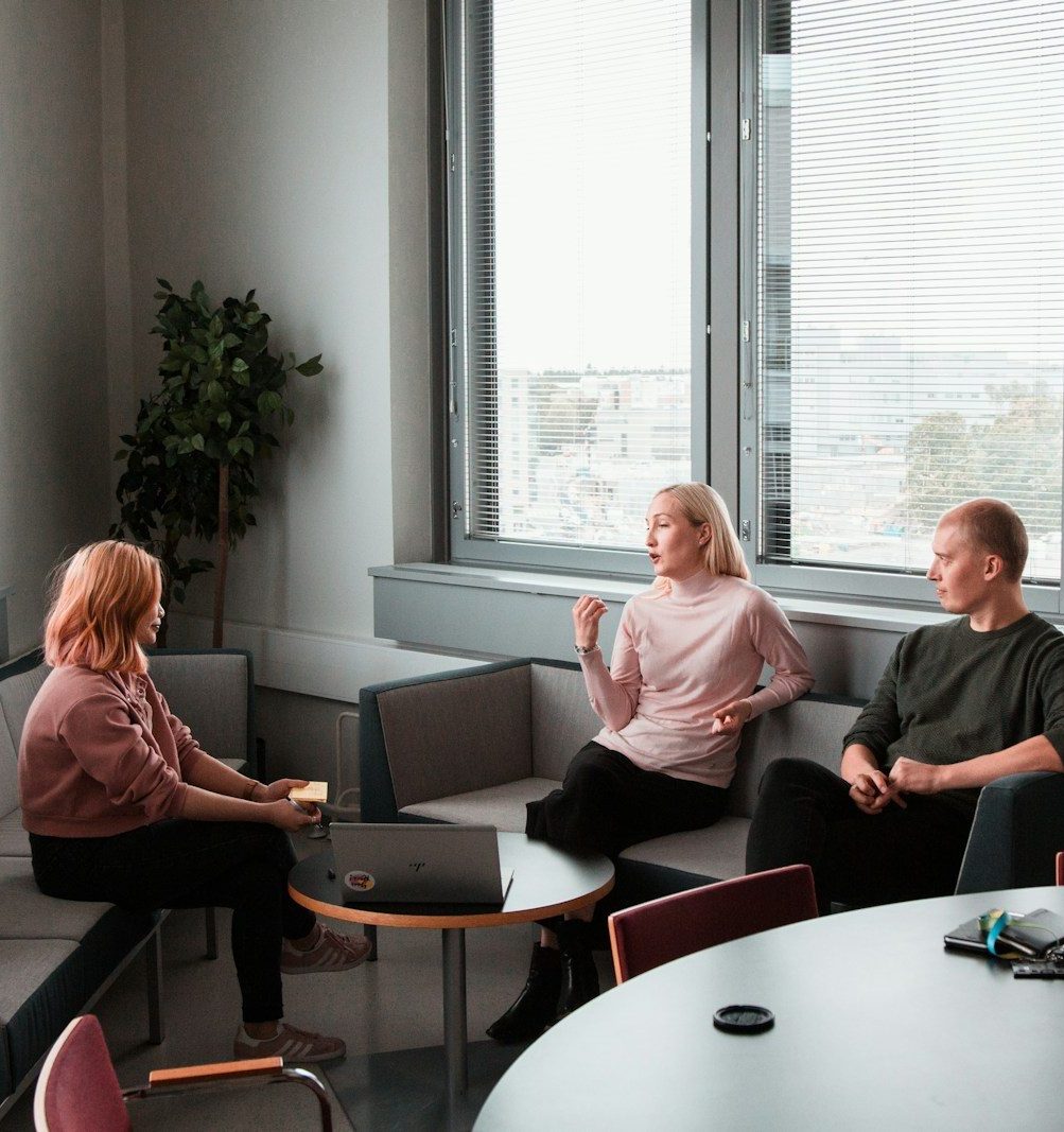 2 women sitting on black sofa